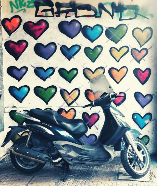 Motorbike in front of street art found in Athens by YROM
